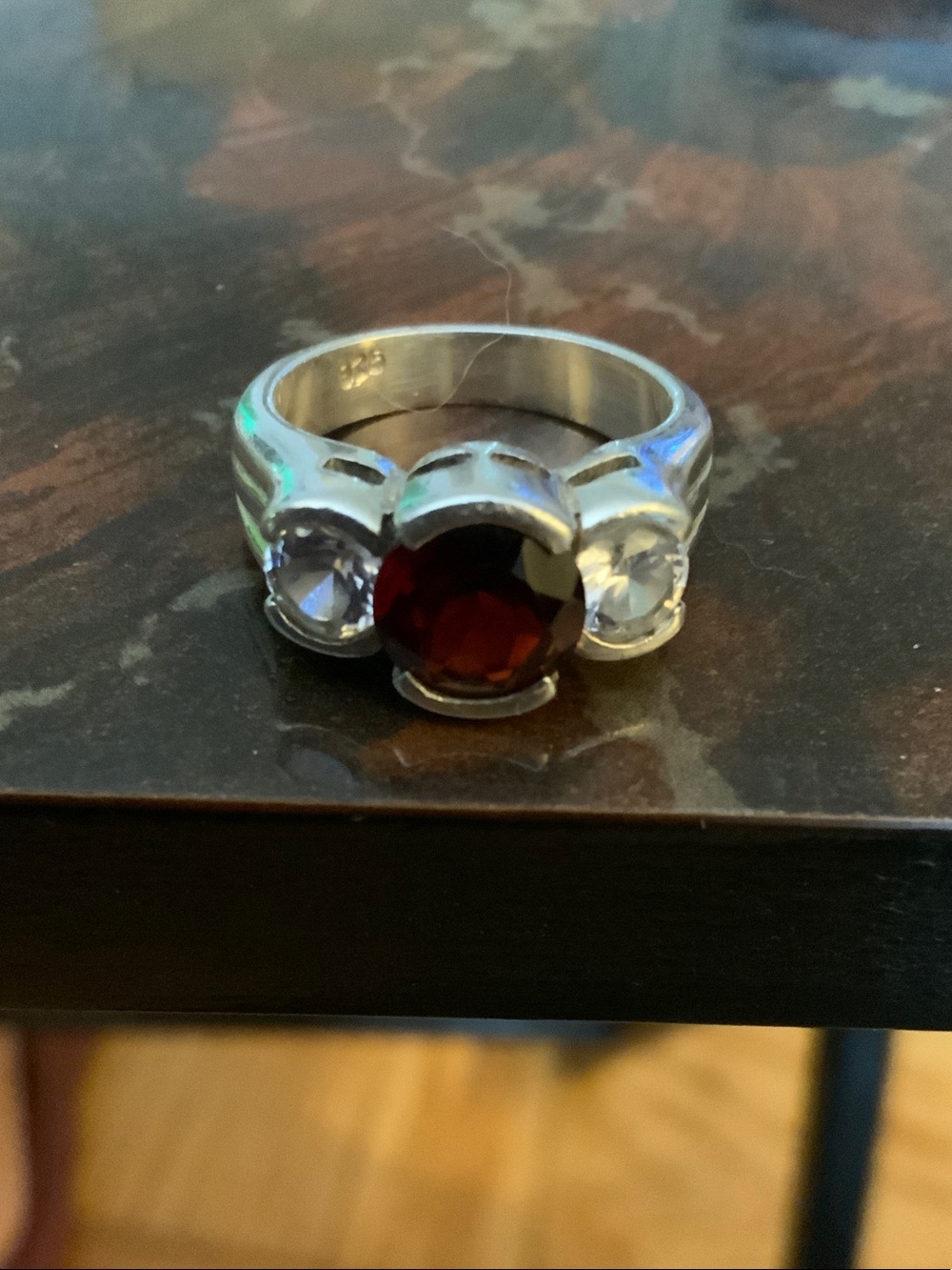 Sterling Silver Ring Garnet Center Stone and CZ Side Stones.